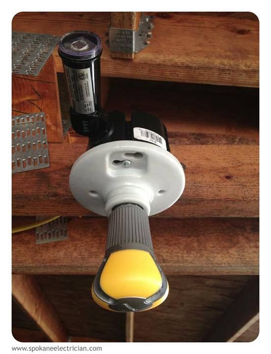A porcelain lamp holder with a photocell mounted under rafters