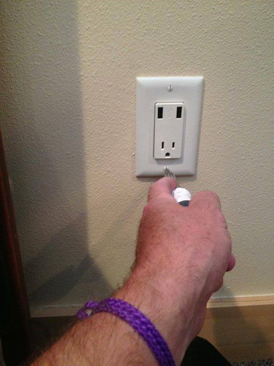 A new outlet with USB ports being screwed in