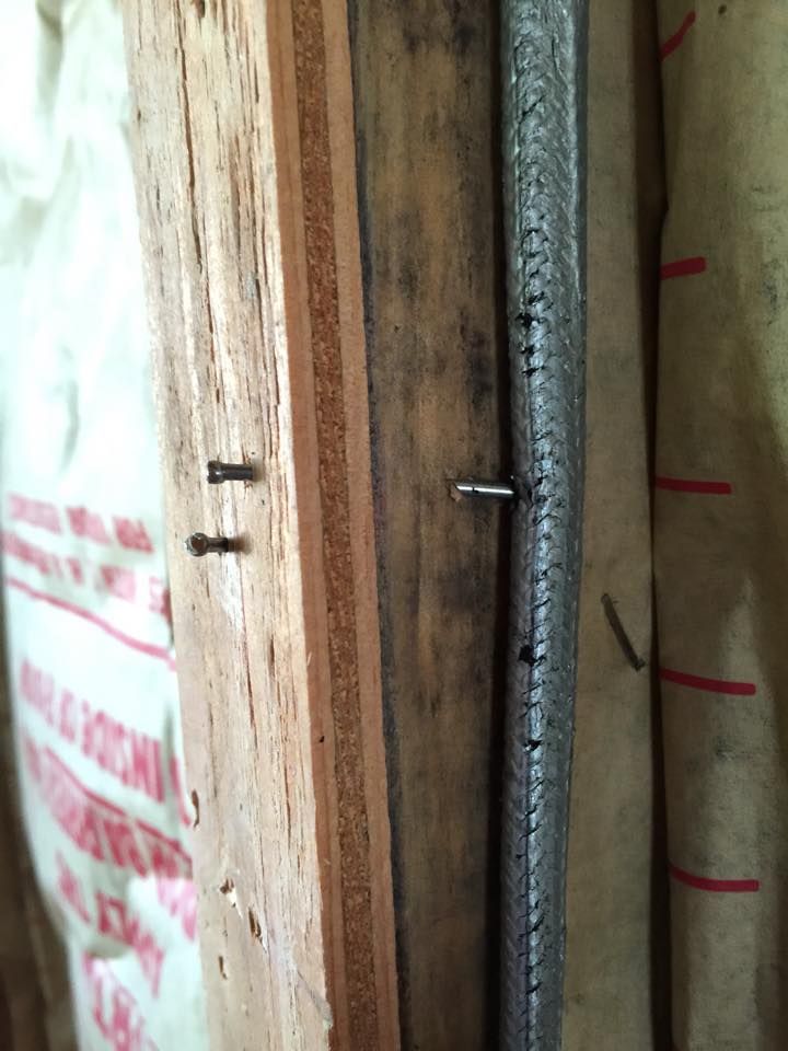 Old cloth-wrapped wiring running inside an open wall