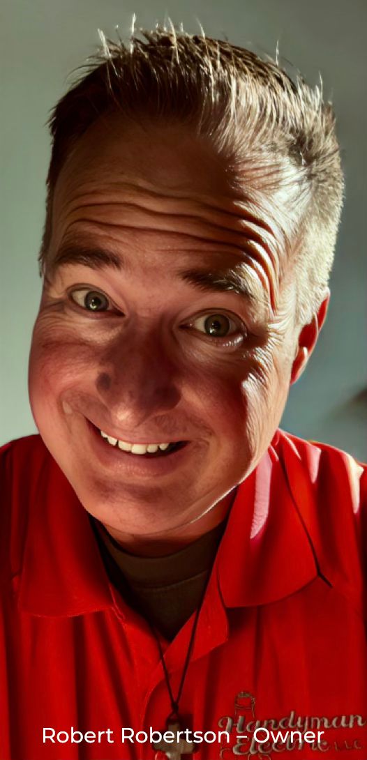 Robert Robertson, owner, smiling in his red Handyman Electric polo