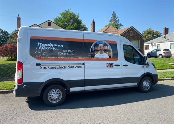 The Handyman Electric van with Robert's portrait and 509.993.0303 on the side