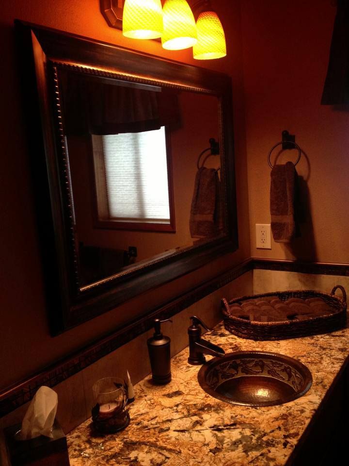 A finished bathroom vanity with its new light fixture switched on