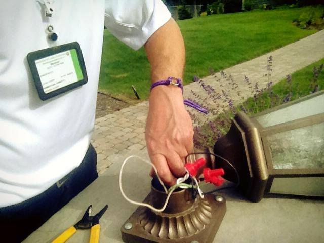 A yard post lamp being rewired
