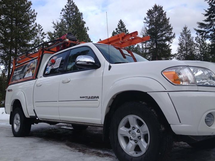 The Handyman Electric pickup with its orange ladder rack in snow